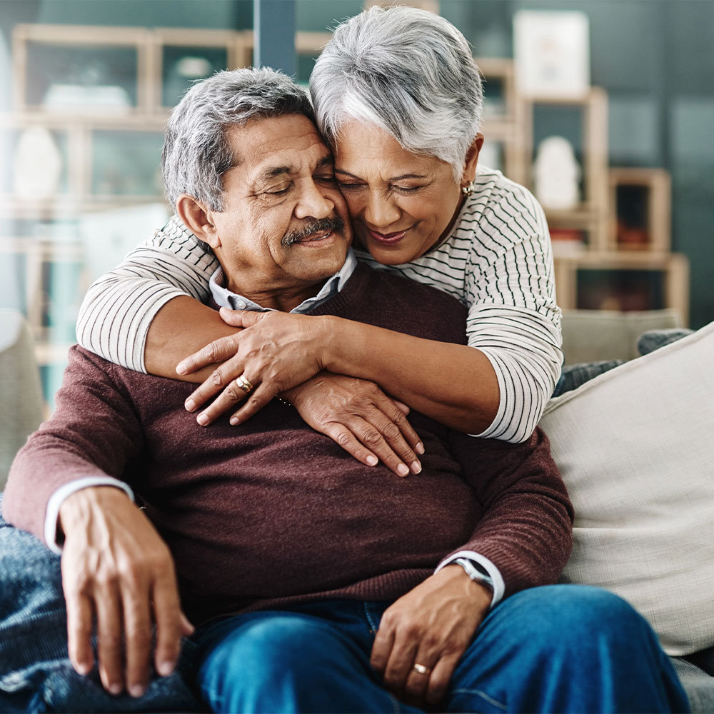 don't miss out two seniors embracing on a sofa