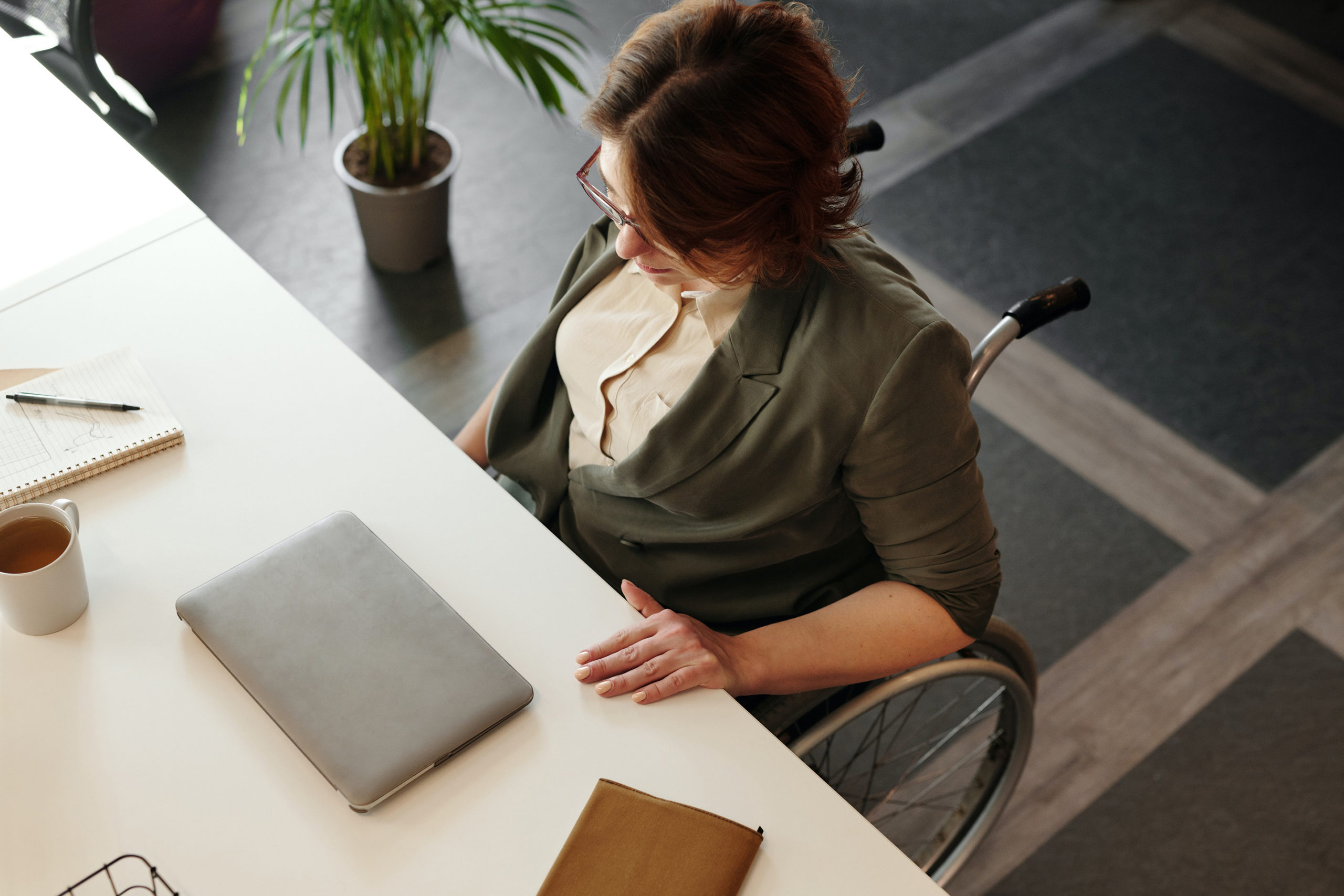 Women in wheelchair doing work at a desk